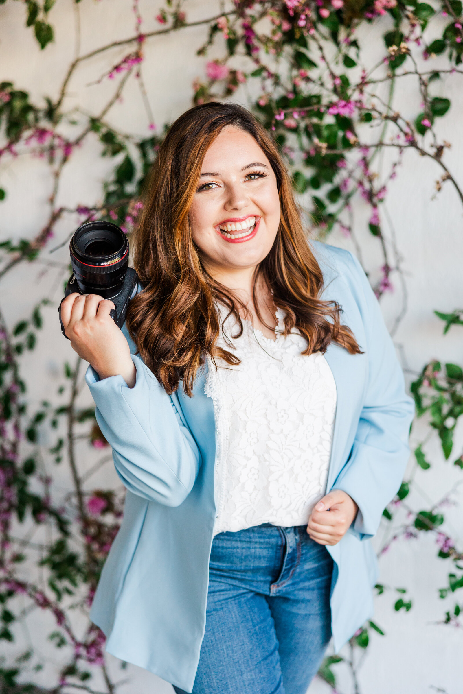 Ivy, the photographer behind Ivy Breanne Photography, holding her camera
